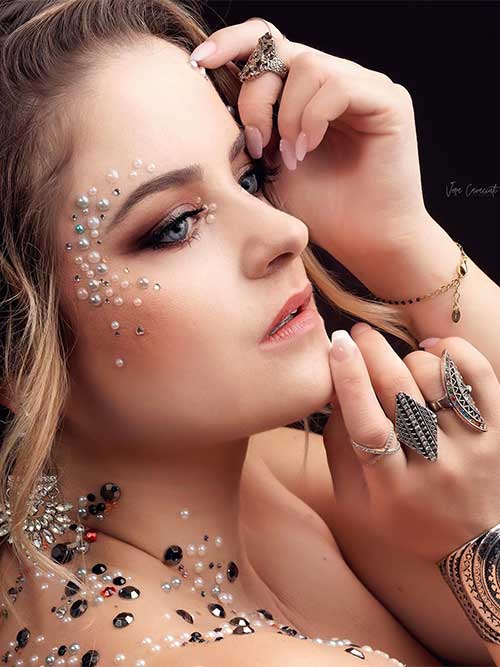 Smokey eye makeup look with nude lips Besides, white pearls and rhinestones are on the inner eye corners, on the face temple