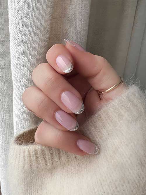 Simple sparkling silver glitter French tip nails are a stunning choice for New Year’s Eve