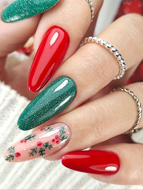 Festive almond-shaped green and red Christmas nails with an accent nude nail adorned with holly nail art