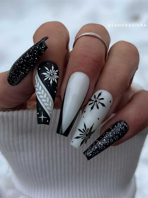 Gel white and black winter nails coffin shaped feature two glossy glitter black nails and snowflake nail art