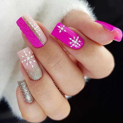 Gorgeous pink and gold glitter Christmas nails adorned with white snowflakes
