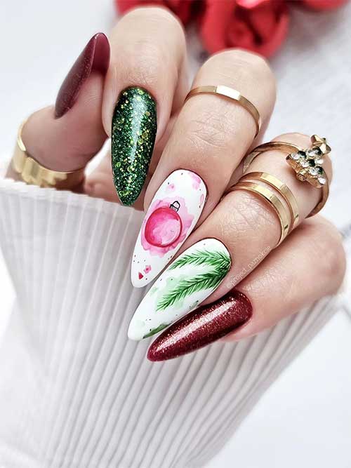 Long almond-shaped glitter dark green and red Christmas nails with two white accent nails adorned with Christmas Tree