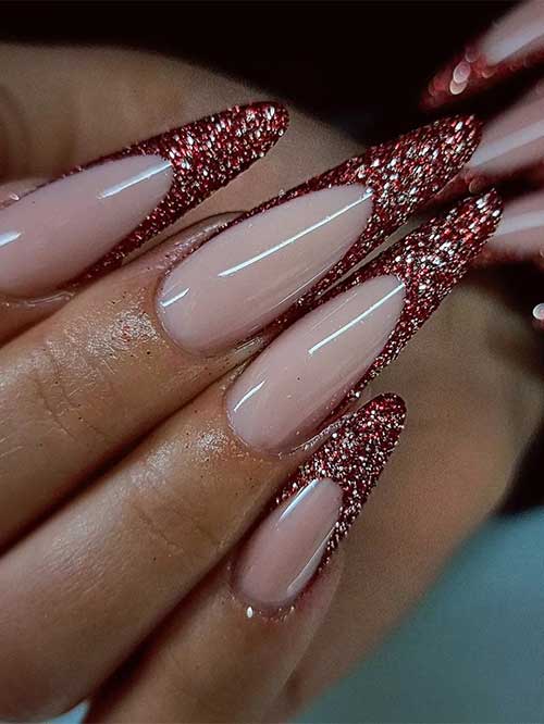 Long almond-shaped rose gold glitter red French nails over a nude base color