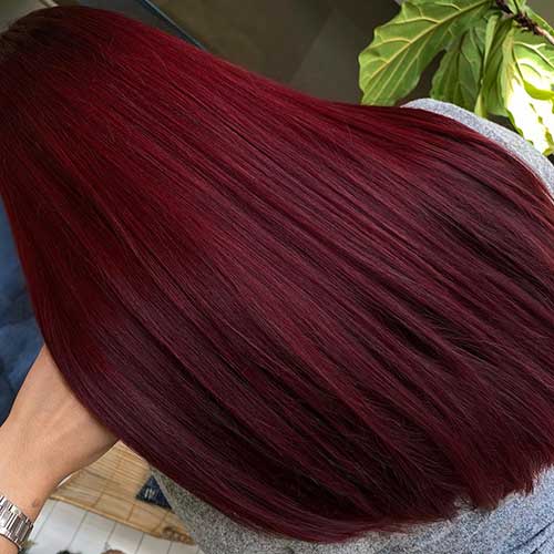 Long hair dyed in burgundy hair color