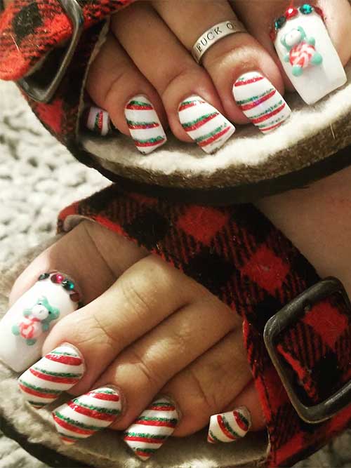 Long white acrylic toenails adorned with glitter red and green candy cane stripes design