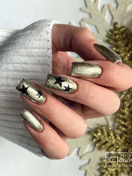 Medium square-shaped sparkling gold New Year's nails with black stars are one of the perfect New Year's nail ideas to try!