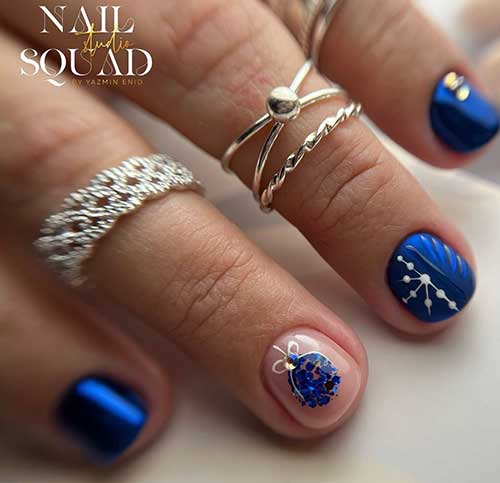 Short chrome navy blue Xmas nails with snowflake nail art and a Christmas ornament nail art on an accent nude nail