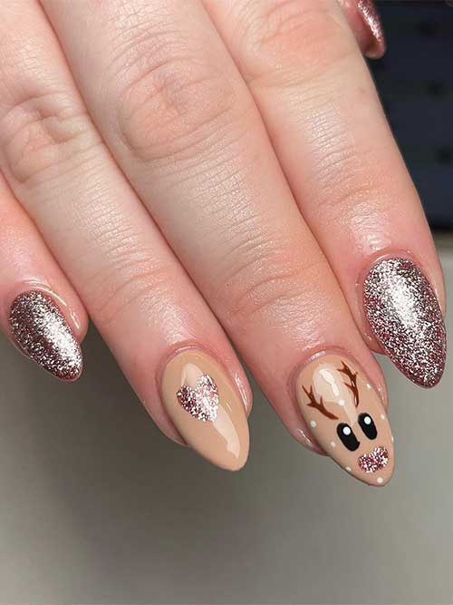  Short rose gold glitter and nude Xmas nails adorned with reindeer and heart nail art designs