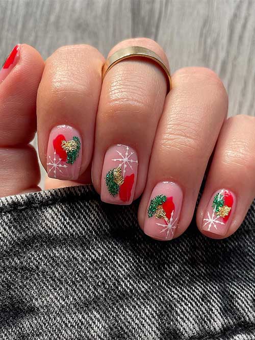 Short square-shaped Christmas nude nails with green, gold, and red abstract nail art in addition to white snowflakes