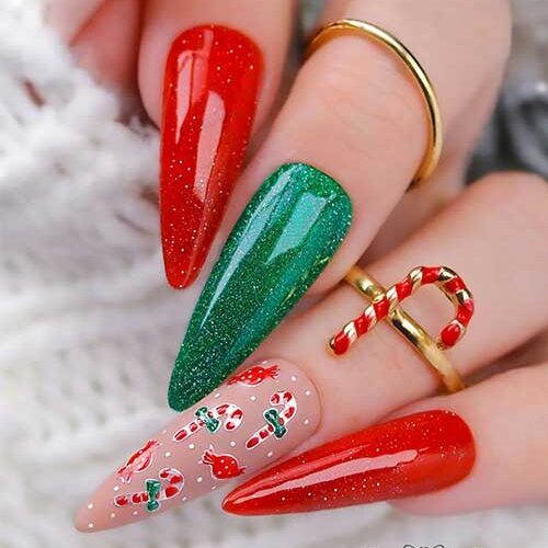 Stunning long almond-shaped nude green and red Christmas nails feature glitter red and green nails with two matte nude nails