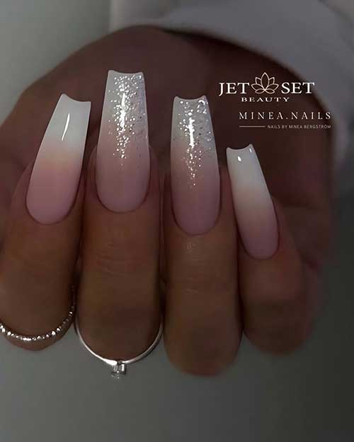 Classy long coffin-shaped French ombre nails with a touch of silver glitter on two accent nails