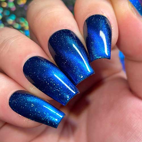 Coffin-shaped Aqua-blue magnetic nails that shine bright with scattered holographic flakes like stars lighting up the sky
