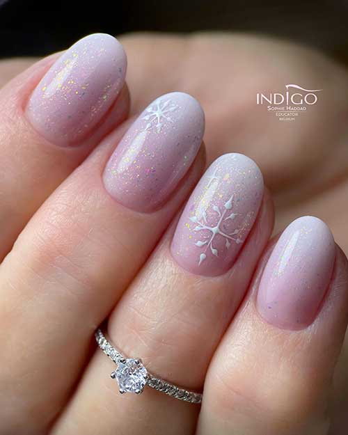 Cute short round round-shaped baby boomer nails with a touch of confetti glitter and snowflakes on two accent nails