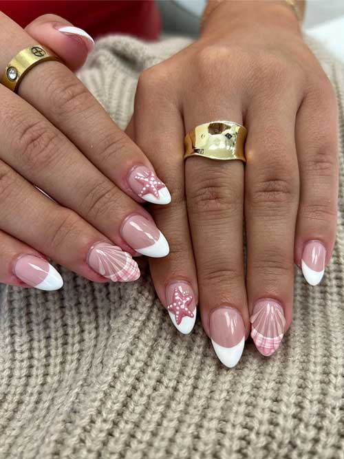 Elegant white French tip nails with soft pink base, featuring seashell and starfish accents for a playful beachy vibe. Elegant white French tip nails with soft pink base, featuring seashell and starfish accents for a playful beachy vibe.