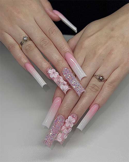 Extra-long baby boomer nails square-shaped with prominent gel flower nail art designs on an accent nail and tiny rhinestones