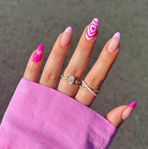 French hot and light pink Valentine’s nails with a hot pink solid nail and a light pink nail with overlapping heart nail art