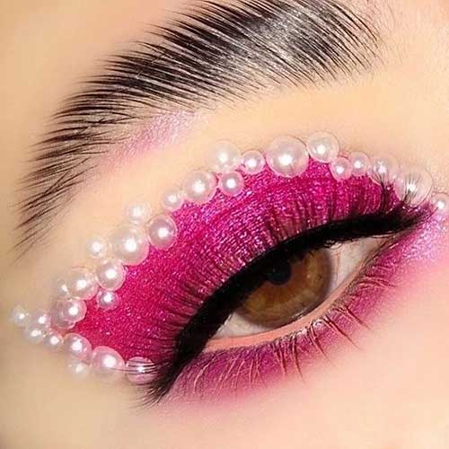 Hot pink Valentine’s Day eye makeup with pearls above the eyeshadow and long lashes