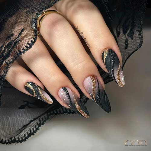 Long almond-shaped black ombre nails with white star nail art. Besides, black glitter and gold glitter swirl nail designs