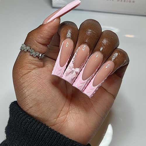 Long square-shaped French Valentine’s nails feature heart sweater nail art