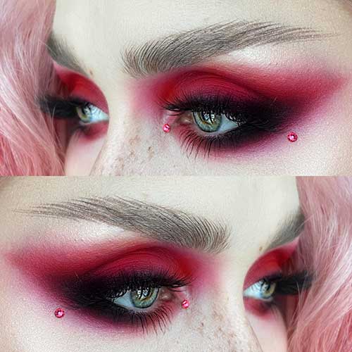 Red Valentine's Day eye makeup with black smokey eyes with a red rhinestone on each of the inner and outer eye corners Red Valentine's Day eye makeup with black smokey eyes with a red rhinestone on each of the inner and outer eye corners