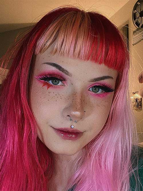 Red and pink Valentine’s eye makeup features a graphic liner, and red lips using lip gloss