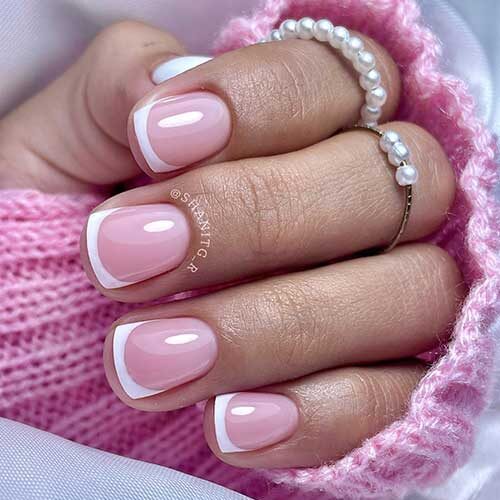 Simple short French tip nails over a nude pink base color