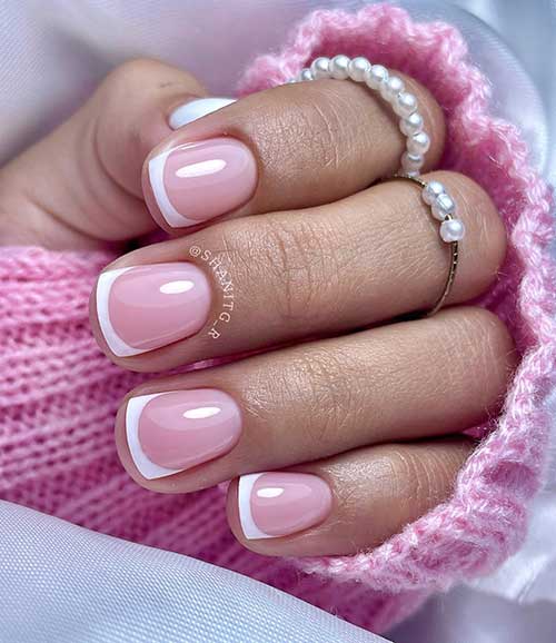 Simple short French tip nails over a nude pink base color
