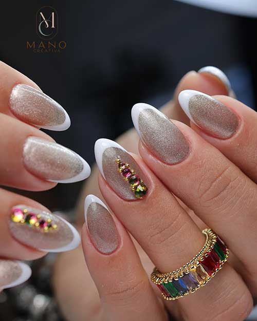 Sparkling white French tip nails almond shape over sparkling rose gold base color Sparkling white French tip nails almond shape over sparkling rose gold base color