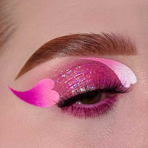 Stunning shimmer pink Valentine's Day eye makeup look with pink ombre heart shapes and brunette eyebrows