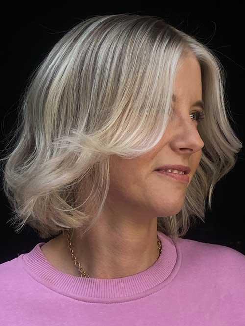 Chic bob haircut with soft waves, side-swept fringe, and icy blonde color, offering a stylish, low-maintenance look. Chic bob haircut with soft waves, side-swept fringe, and icy blonde color, offering a stylish, low-maintenance look.