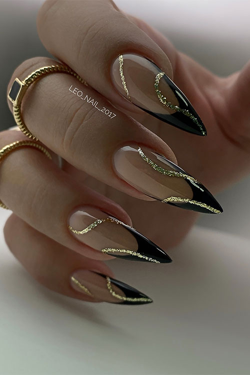 Classy stiletto black French tip nails with gold glitter swirl nail art