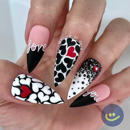 Creative black and white heart nail design features two black French nails, black rhinestones, and two heart nails