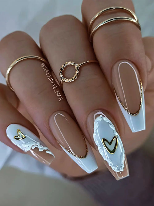 Creative light blue French coffin pastel Valentine’s Day nails with gold decorations and heart shapes