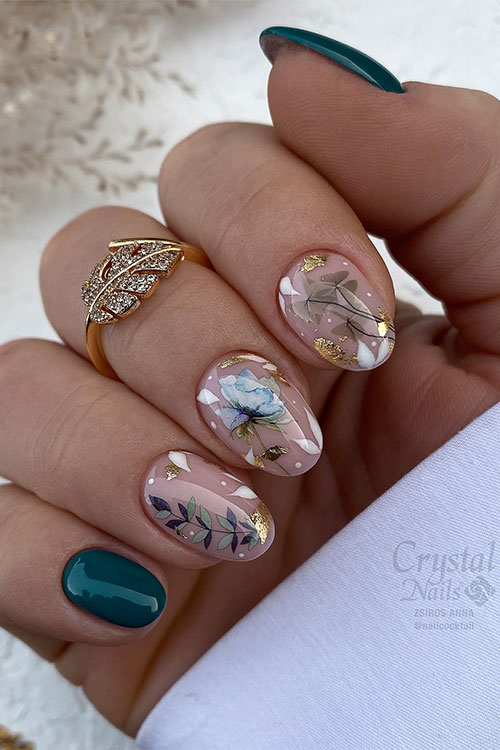 Dark green and nude nail design features flower and leaf nail art designs with gold foil decorations on three nude accents