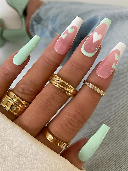 Long Coffin simple pastel Valentine’s Day nails feature mint green nails adorned with heart shapes on French accent nails