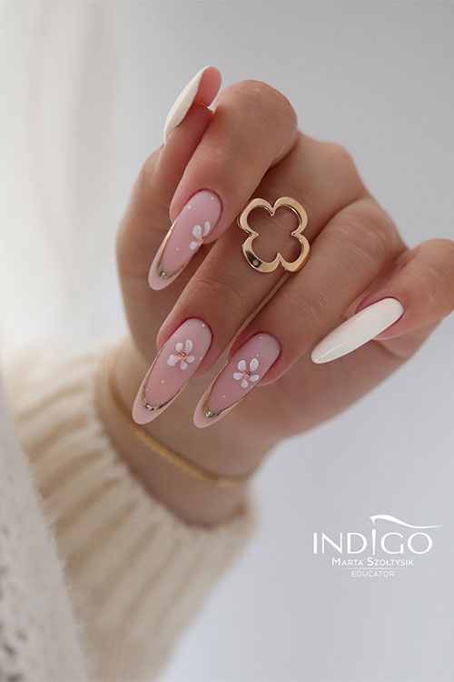 Long almond-shaped flower spring nails feature three nude pink French tips decorated with a golden French coat and flowers