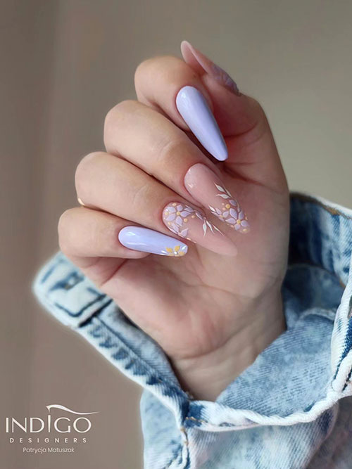Long almond-shaped lilac floral negative space nails with two accent solid lilac nails