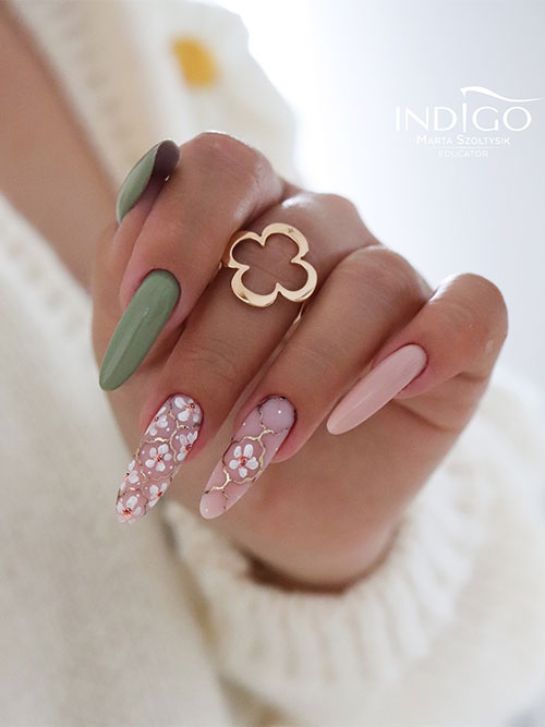 Long almond-shaped sage green and nude pink spring nails adorned with daisy flowers and gold decorations on two accents Long almond-shaped sage green and nude pink spring nails adorned with daisy flowers and gold decorations on two accents