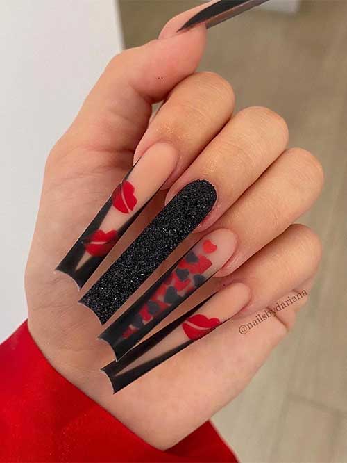 Long black V-shape French tip nails with a black glitter accent nail and a V French nail adorned with black and red hearts