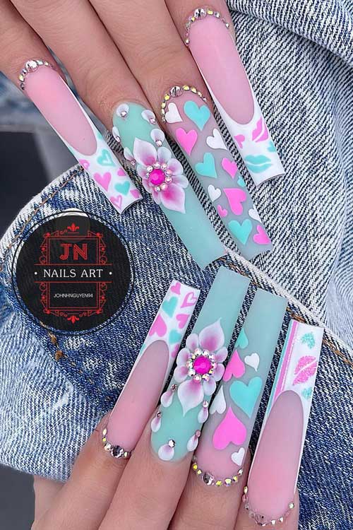 Long coffin mint green and white pastel Valentine’s Day nails adorned with rhinestones, floral nail art, and heart shapes