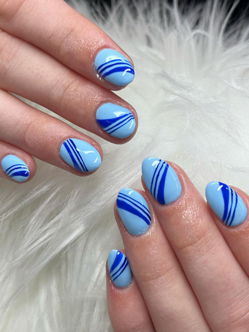 Short dark blue line nails over light blue base color
