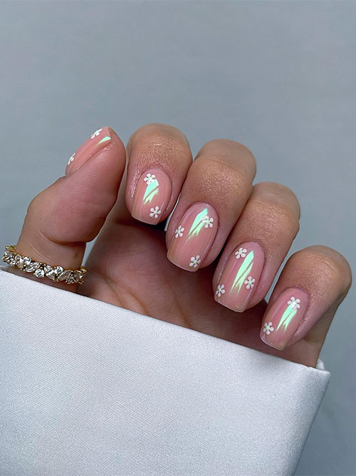 Simple flower spring nails feature tiny daisy flowers on a nude base color adorned with a chrome powder effect Simple flower spring nails feature tiny daisy flowers on a nude base color adorned with a chrome powder effect