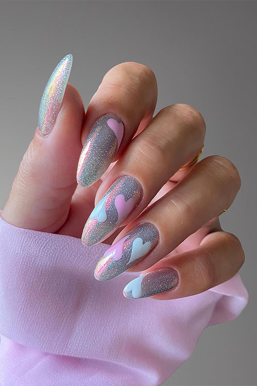 Sparkling long almond silver glitter nails with light pink and light blue heart shapes