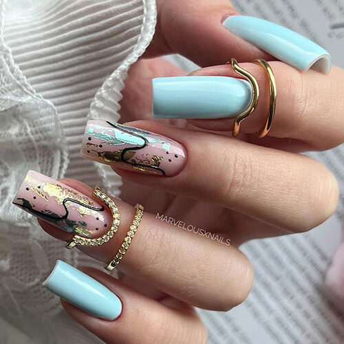 Discover the enchanting beauty of light blue nails adorned with abstract nail art
