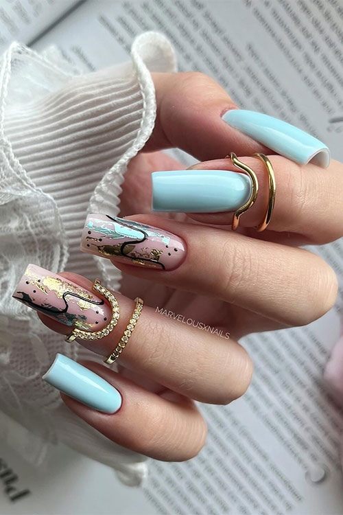 Discover the enchanting beauty of light blue nails adorned with abstract nail art