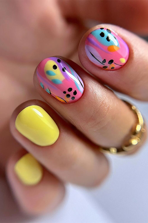 Get ready to shine with short vibrant yellow nails with colorful abstract nail art accent nails that exude joy and energy