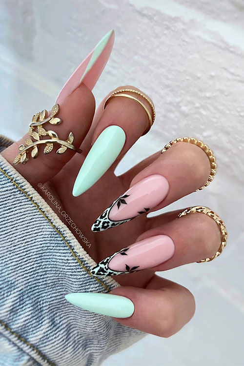 Long stiletto-shaped classic French mint green spring nails adorned with black leaves and black leopard prints on the tips