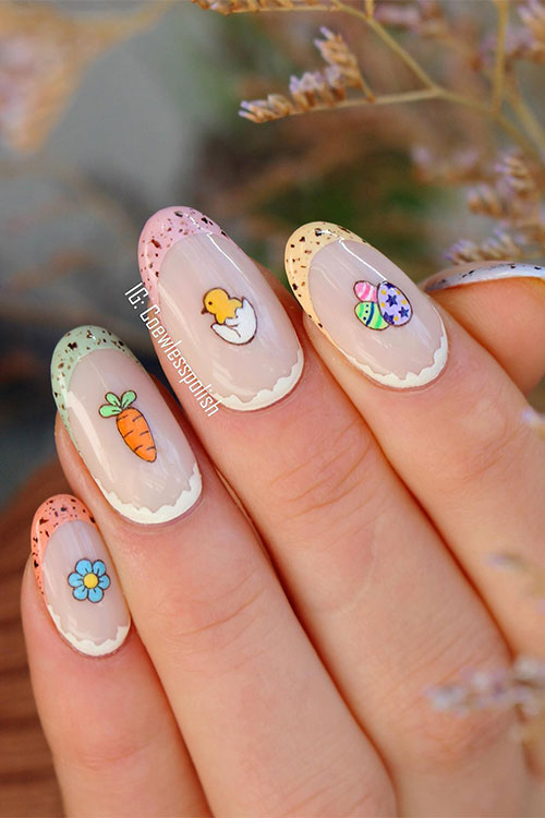 Short multicolored Easter French tip nails with speckled tips and charming chick, carrot, egg, and flower designs