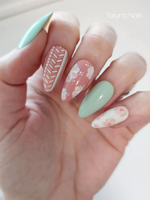 White, nude, and mint green nail design features solid almond-shaped mint green nails with floral nude and white accent nails