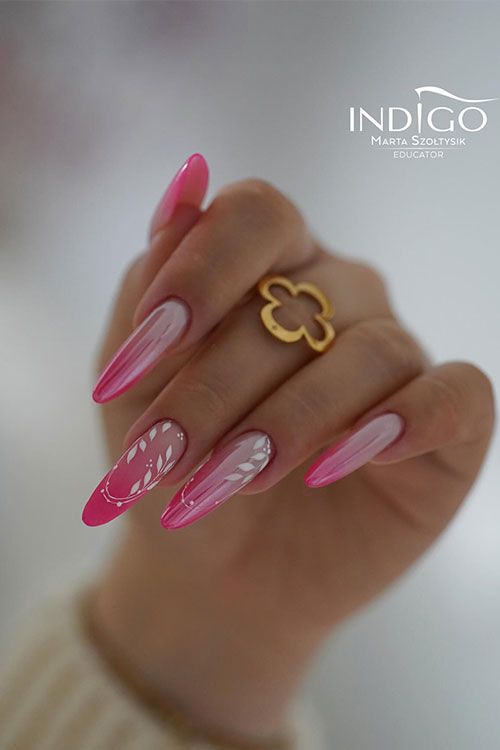 Long almond-shaped hot pink ombre nails with chrome effect and two accent nails adorned with white leaf nail art